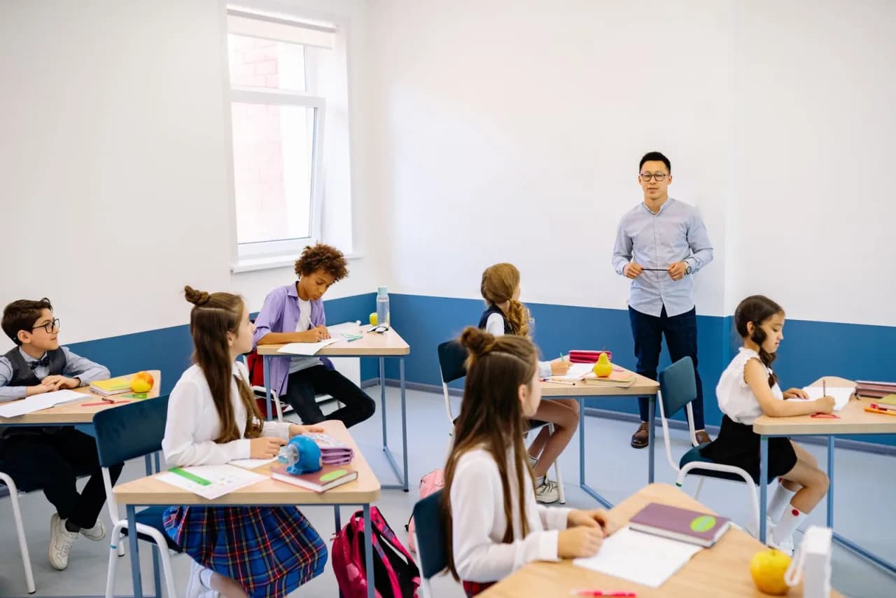 Съвременен преподавател работи с група ученици
